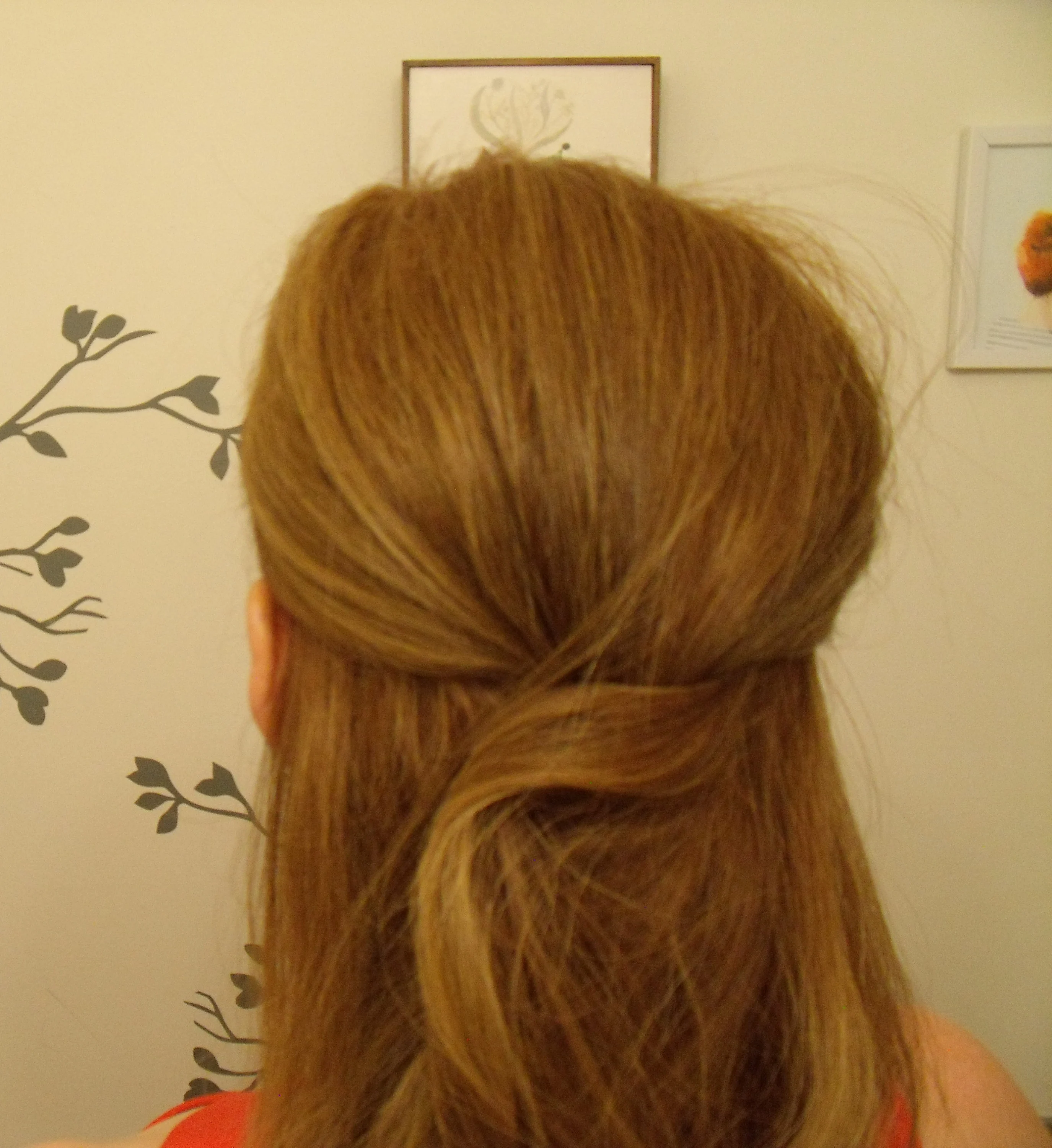 Bobby pins in place holding the hair half up.